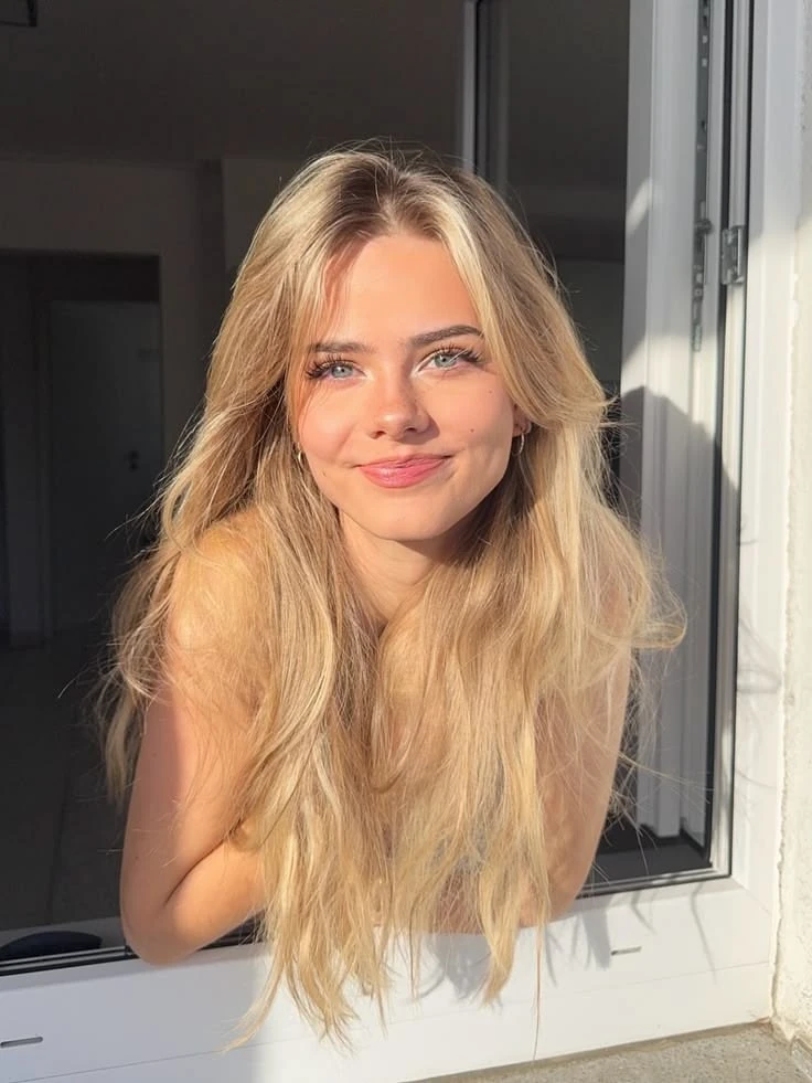 Warm, sunlit portrait at an open window